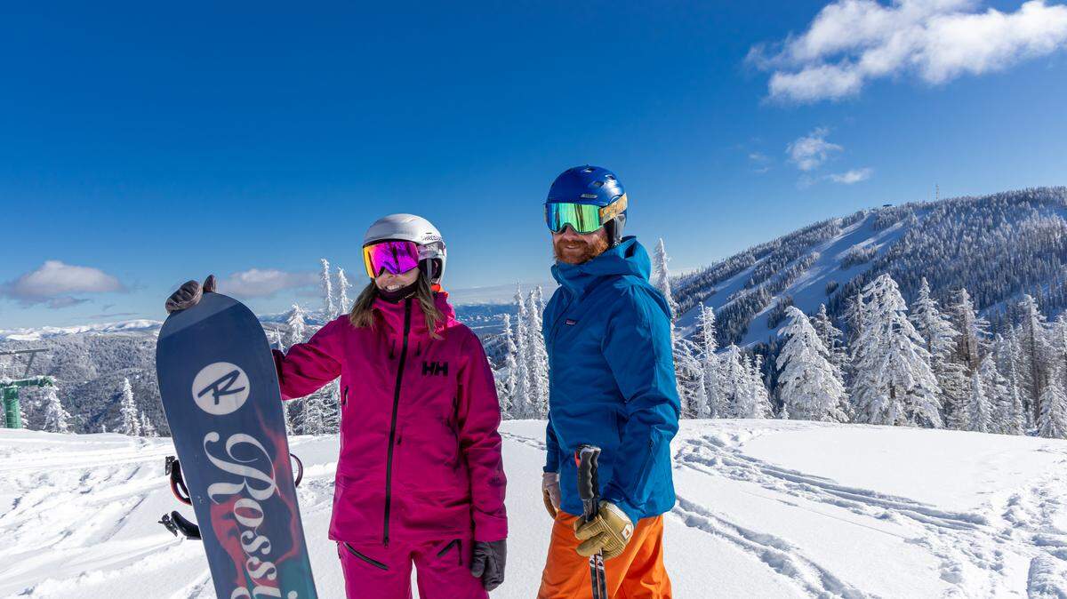 A snowboarder and skier are shown at 49°North Mountain Resort in Chewelah, Washington.