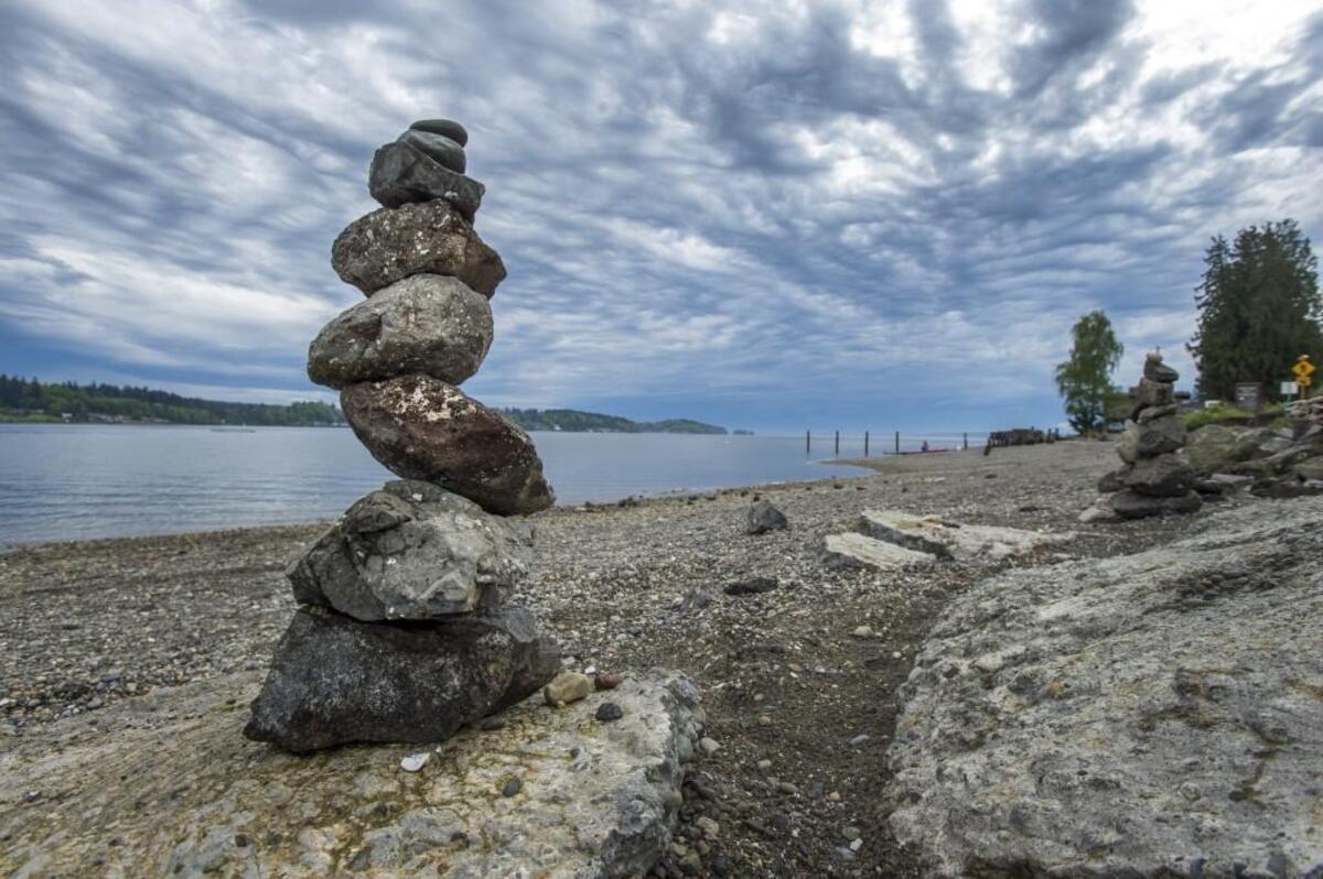 Ominous clouds of an approaching thunderstorm frame this stack of rocks piled by a beachcomber on the Purdy spit. Photo taken in Purdy on Thursday, May 4, 2017.