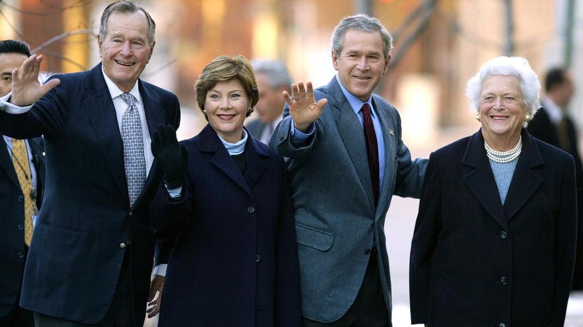 In 2003, former President George H.W. Bush, then-first lady Laura Bush, then-President George W. Bush and former first lady Barbara Bush wave to reporters outside St. John’s church in Washington, D.C.
