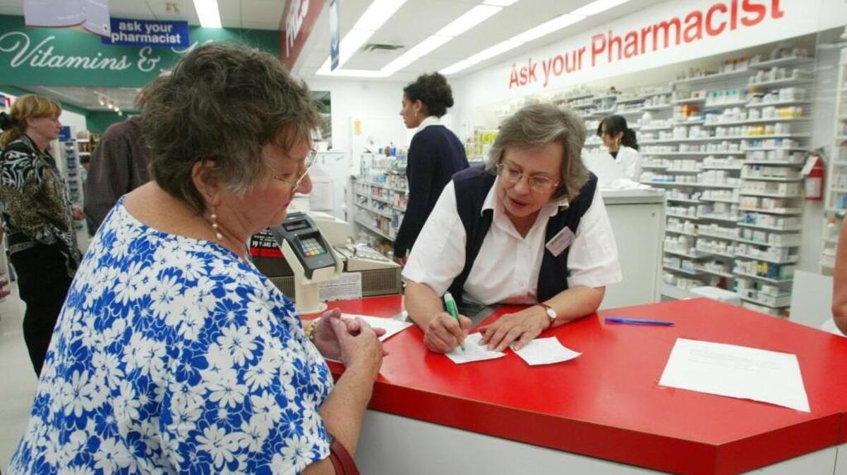Alice Harris, 65, of Kennewick, submits her prescriptions to pharmacy technician Fran Plaskett at Shoppers Drug Mart in Osoyoos, British Columbia. Harris was turning in 13 prescriptions that normally cost her $600 a month in the United States. She saved about 30 percent in Canada.