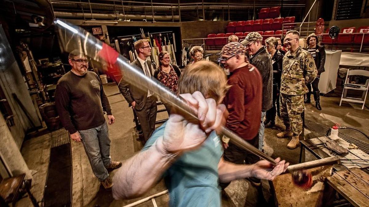 Instructor Greg Owen spins a piece of glass during a demonstration at Tacoma’s Museum of Glass, where visiting dignitaries were taking a look at the Hot Shop Heroes program. The NEA-funded program partners with JBLM to teach glassblowing skills to active-duty military and veterans for healing.