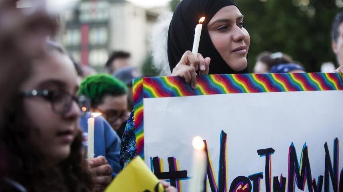 Zuleyha Ozonder, who is Muslim, holds a candle and a sign to show that many in the Islamic faith support the LGBT community during a vigil in Seattle on June 12, in response to a mass shooting earlier that day at a gay nightclub in Orlando, Florida.