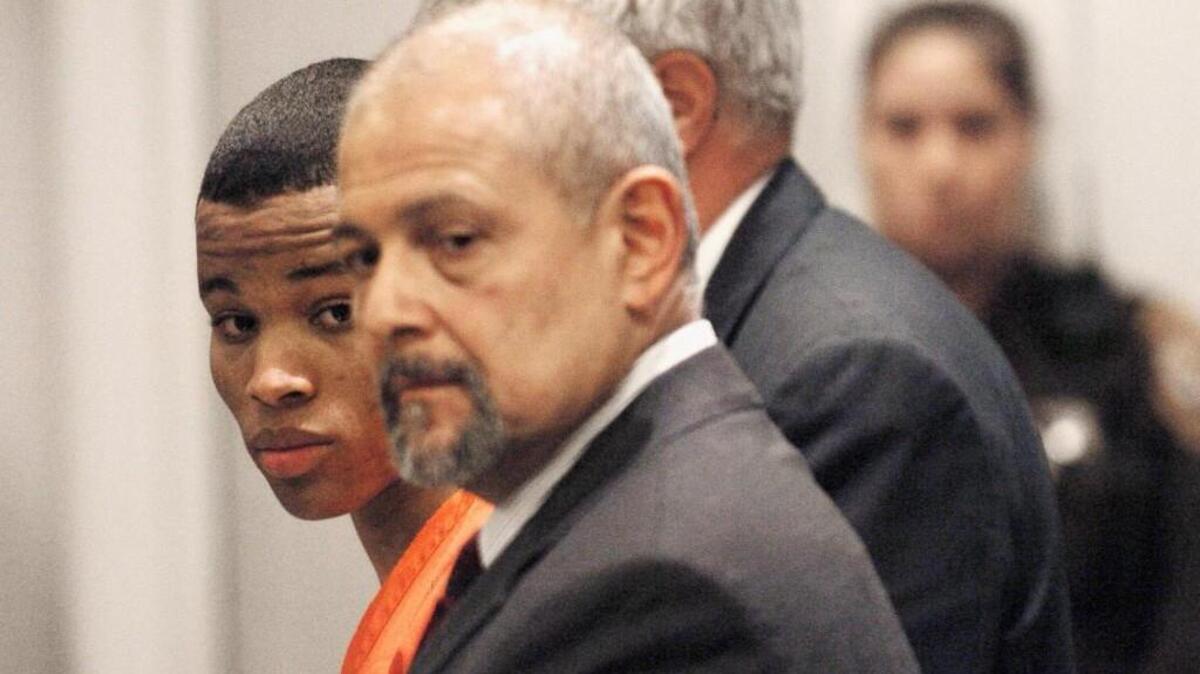 Lee Boyd Malvo, left, is flanked by his attorneys in a circuit court in Virginia in 2004. Malvo struck a deal in which he avoided the death penalty and was sentenced as an adult to life without parole for one of his D.C. Sniper attacks. Because he was still a child at the time of his shooting spree 15 years ago, Malvo will now be granted a resentencing hearing.