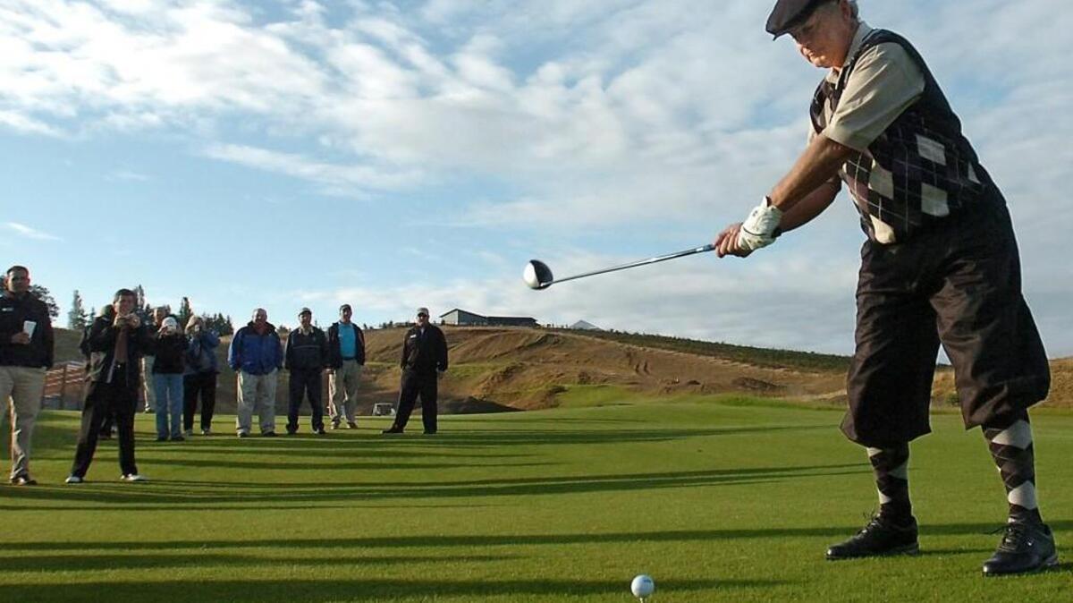 Former Pierce County Executive John Ladenburg hits the ceremonial first tee shot during the opening of the Chambers Bay Golf Course in University Place on June 23, 2007. Ladenburg was wearing a Scottish outfit called "plus fours," in honor of the Scottish links-style golf course.