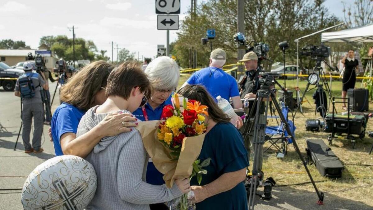 Chaplains Sharon Folsom, left, and Jeanie Tidwell, second from right, of Billy Graham Rapid Response Team, pray with Belinda McLaurin, right, and her 14-year-old granddaughter, Randi Ray Rivera, on Tuesday near the scene of Sunday’s mass shooting at First Baptist Church in Sutherland Springs, Texas. McLaurin said she is a former member of the congregation, and she knew every victim of the shooting.