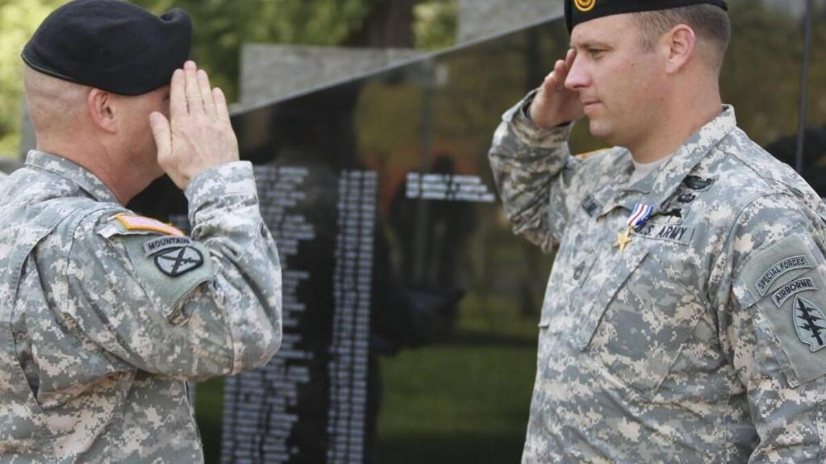 Sgt. 1st Class Earl D. Plumlee, right, is presented the Silver Star by Maj. Gen. Kenneth R. Dahl, I Corps deputy commanding general, during a ceremony at Joint Base Lewis-McChord last year. Plumlee might yet receive the nation’s highest valor medal.