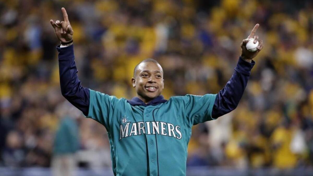 Former Curtis High and University of Washington basketball player and current Boston Celtics player Isaiah Thomas waves to the crowd before throwing out the ceremonial first pitch before a game between the Seattle Mariners and Minnesota Twins Friday.