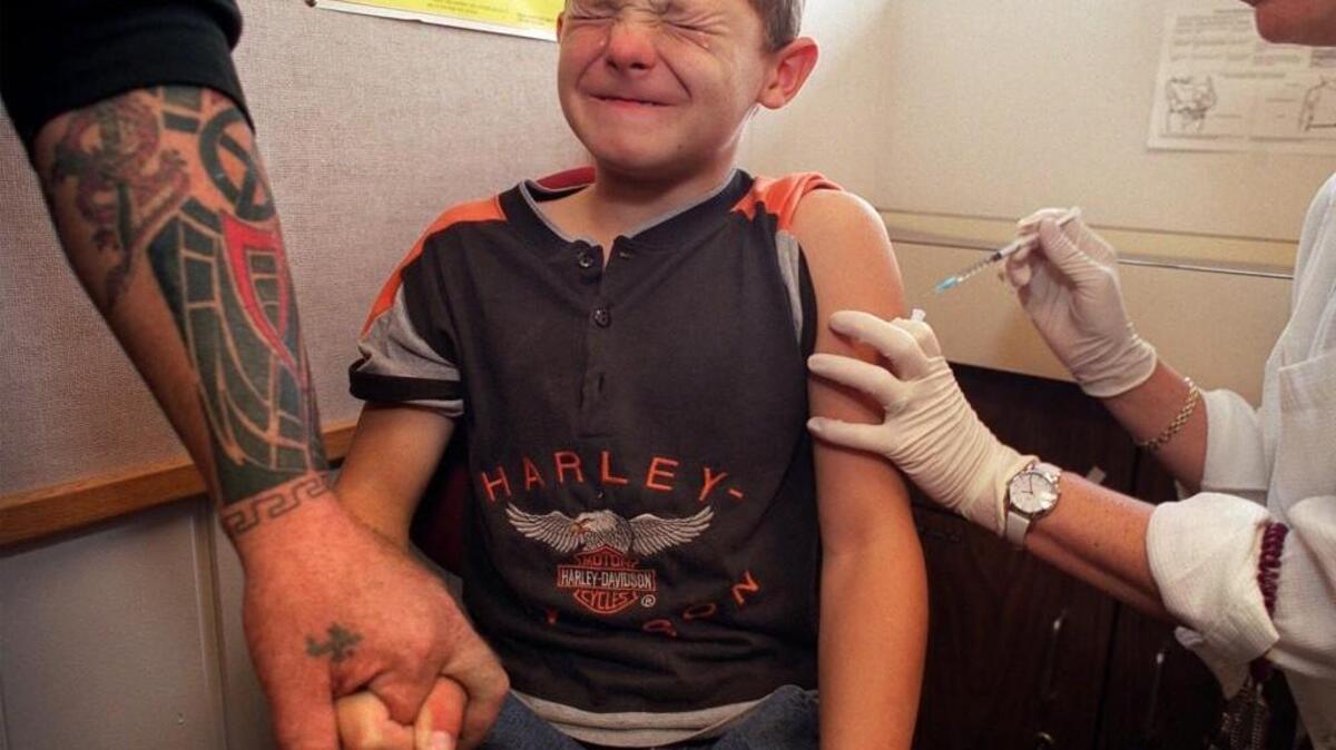 Michael Koutrouba apprehensively receives a measles, mumps and rubella shot from a nurse at Good Samaritan Hospital in Puyallup in 2001, while his dad holds his hand for strength. Washington allows parents to opt out of vaccination for philosophical or personal reasons in addition to medical and religious exemptions.