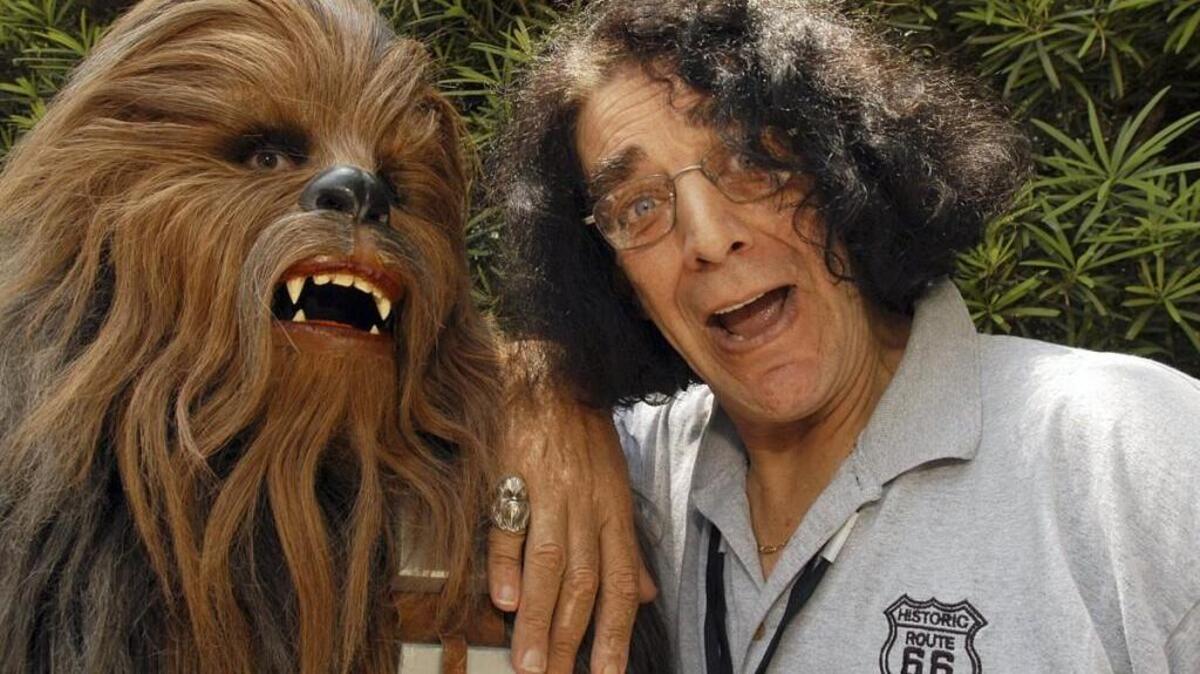 Things that make you go “WRAAAAGHHH!” Gotta wonder if all the personal fireworks blowing up around here this weekend will hurt the big fella’s ears. Chewbacca (left) is shown at a 2005 Walt Disney World appearance with actor Peter Mayhew.