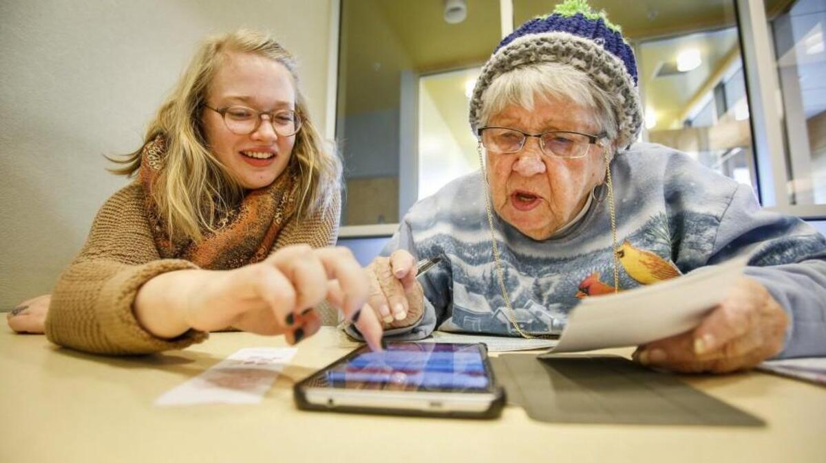 Librarian Kendall Brookhart, digital literacy coordinator for the Pierce County Library System, works with Mary Sinclair, 80, to help her sign into a website on her new tablet at the Milton-Edgewood library branch.