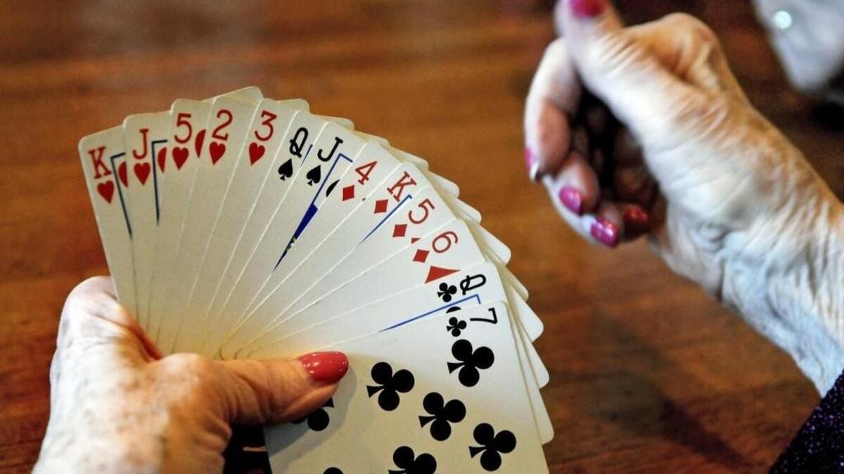 A card player studies her hand during a bridge game. As part of Pierce County’s “Game Campaign,” people of all ages are playing backgammon, bridge, chess, Go and Scrabble to build the habit of mental workouts.