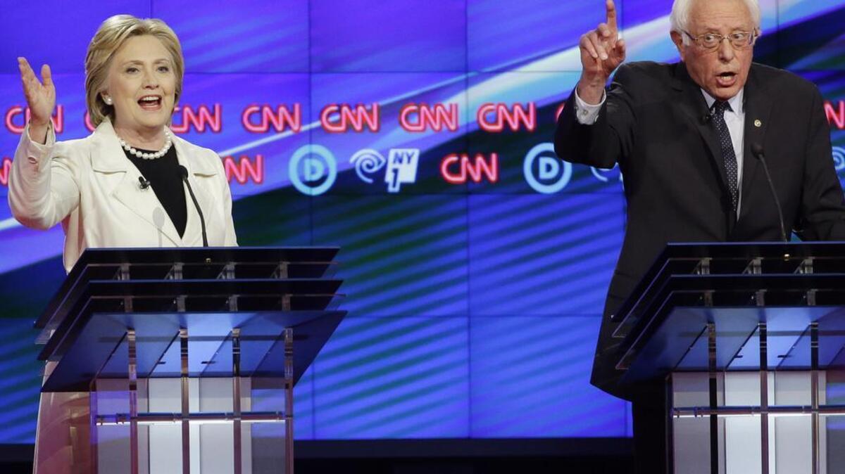 Democratic presidential candidates Sen. Bernie Sanders and Hillary Clinton speak during the CNN Democratic Presidential Primary Debate at the Brooklyn Navy Yard on Thursday in New York.