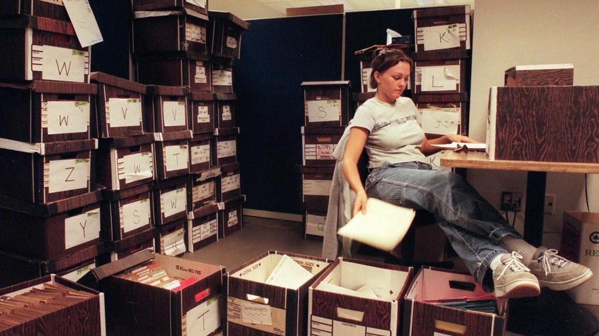 Temporary employee Melissa Joyner examines and tosses old law school records at the former University of Puget Sound law school after it was sold to Seattle University. Five years after the sale, the whole operation was moved from the Rhodes Building in downtown Tacoma up the freeway to Seattle.