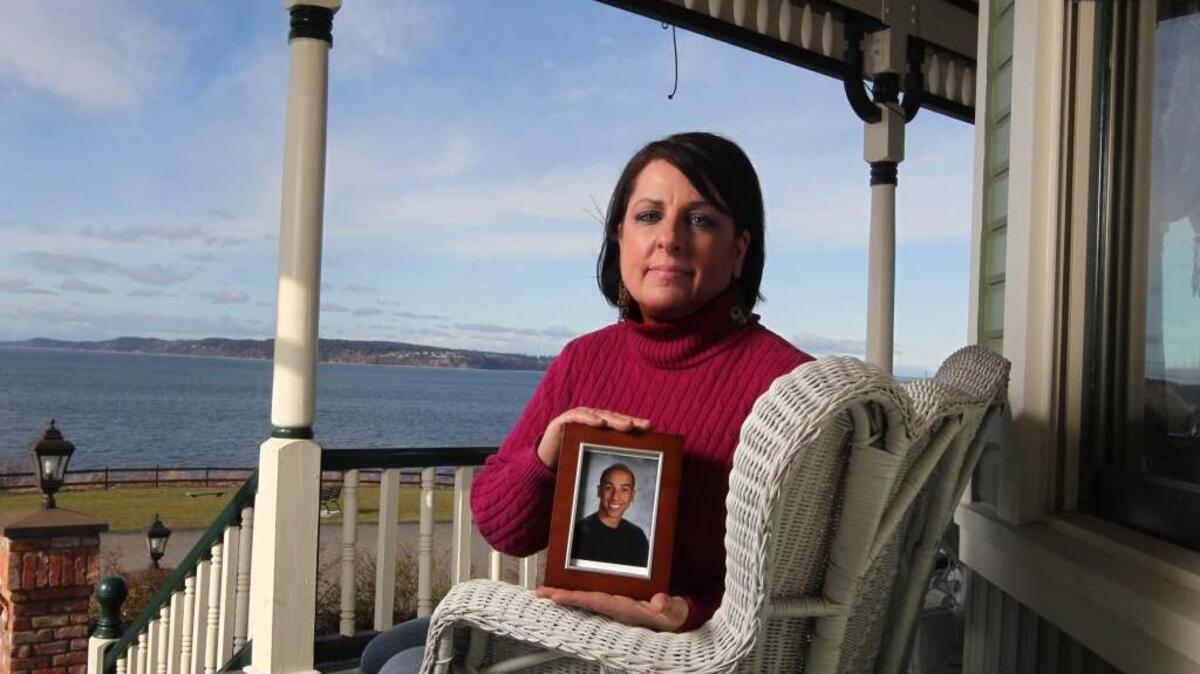 Deborah Binion holds a photo of her 17-year-old son Jordan, who killed himself in 2010. The family has since helped pass a state law reinforcing parental rights of youths struggling with mental illness, and established a nonprofit that does mental health presentations for high school students. Her son might have benefited from a new inpatient facility opening in Tacoma this week.
