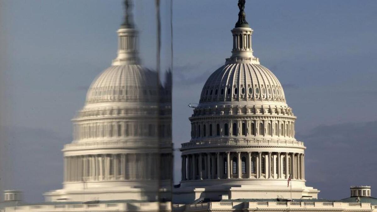The Capitol reflected in the windows of the Newseum, on Pennsylvania Avenue in Washington. (AP Photo/Jacquelyn Martin, File)