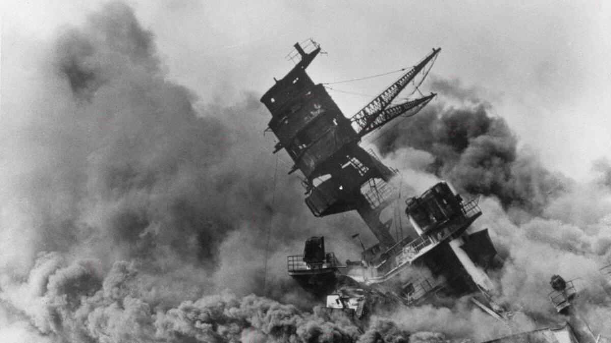 In this Dec. 7, 1941, file photo, the battleship USS Arizona belches smoke as it topples over into the sea during the Japanese surprise attack on Pearl Harbor, Hawaii.