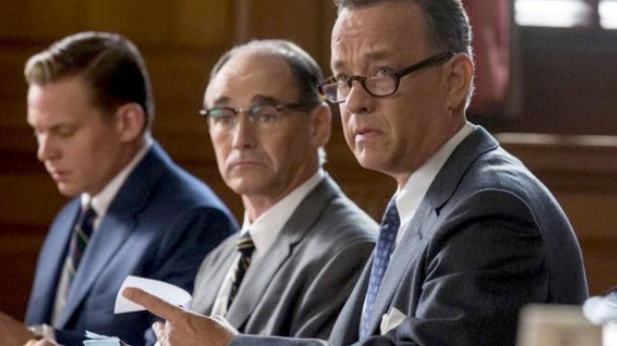 Tom Hanks, right, plays James Donovan and Mark Rylance, center, is Soviet spy Rudolf Abel in Steven Spielberg's Cold War thriller "Bridge of Spies." But the period's most important character was left on Spielberg's cutting-room floor.