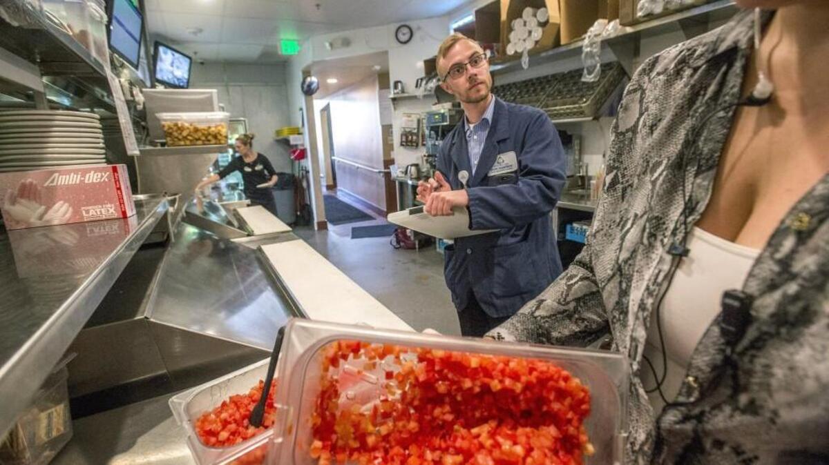 Matt Hadorn, a food specialist with Tacoma-Pierce County Health Department, performs a routine check at Bob's Burgers & Brew in South Hill. When food-service establishments in Pierce County are forced to close for health reasons, patrons don’t have an easy way to get information.