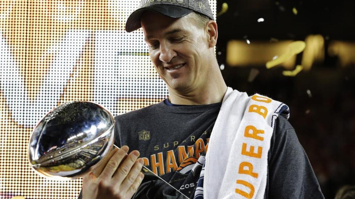 Denver Broncos quarterback Peyton Manning holds up the trophy after the NFL Super Bowl 50 football game Sunday in Santa Clara, California. The Broncos beat the Panthers 24-10.