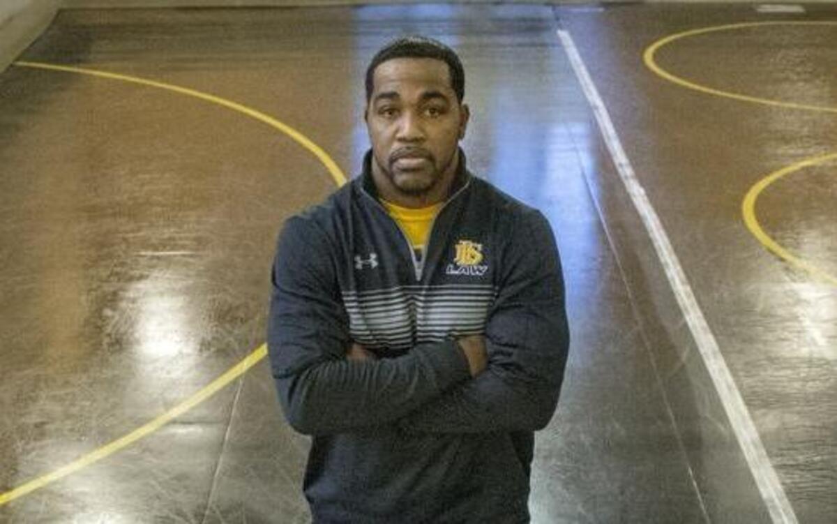 Lincoln High School wrestling coach Greg Ford with three of his top athletes in what would turn out to be his last season at Lincoln.