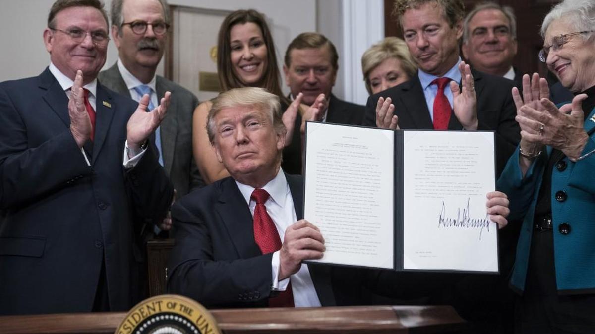 President Trump signs an executive order on health care at the White House Thursday.