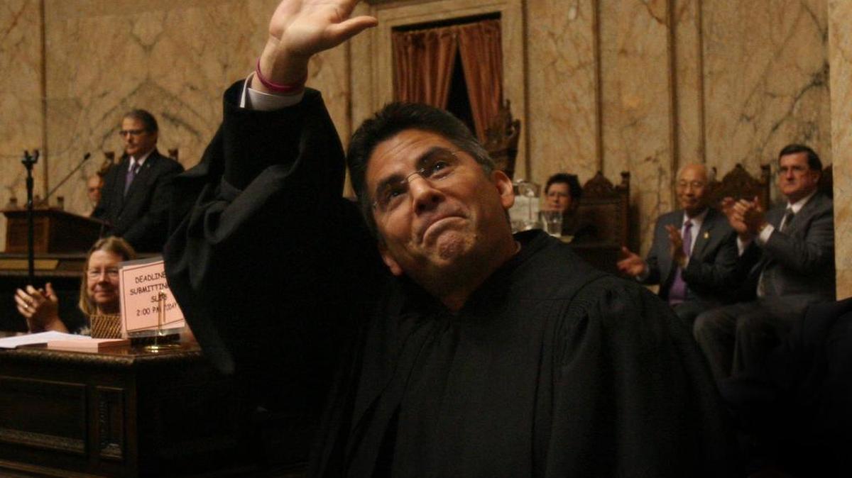 Newly sworn-in Washington State Supreme Court Justice Steve Gonzalez waves to the House gallery after his introduction Tuesday before Gov. Chris Gregoire’s State of the State address in 2012.