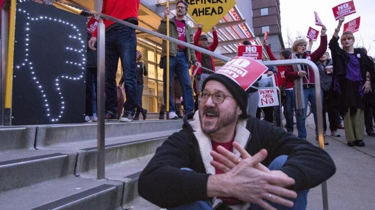 The week after methanol plant developers paused their work in Tacoma, protesters did not pause their efforts. Tacoma resident Doug Mackey cheers a speaker at a rally outside the Greater Tacoma Trade and Convention Center on Feb. 24. "I think we're fighting for the very soul of our city," he said.