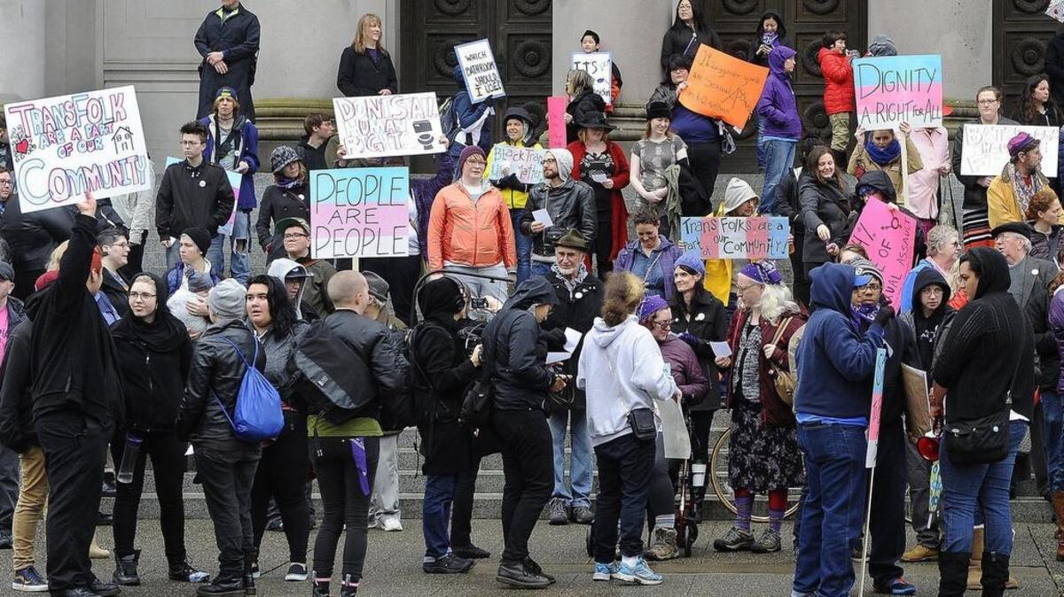 Supporters of the new state rule which allows transgender access to rest and locker rooms of their chosen gender stand on the steps of the Temple of Justice in Olympia Monday as they stage a counter protest to a competing rally by opponents of the new rule who amassed in front of the Legislative Building.
