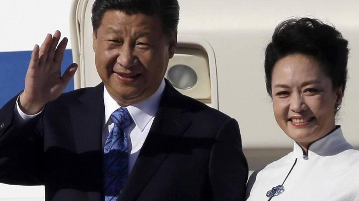
Chinese President Xi Jinping and his wife Peng Liyuan wave upon arrival Tuesday at Boeing Field in Everett. 

