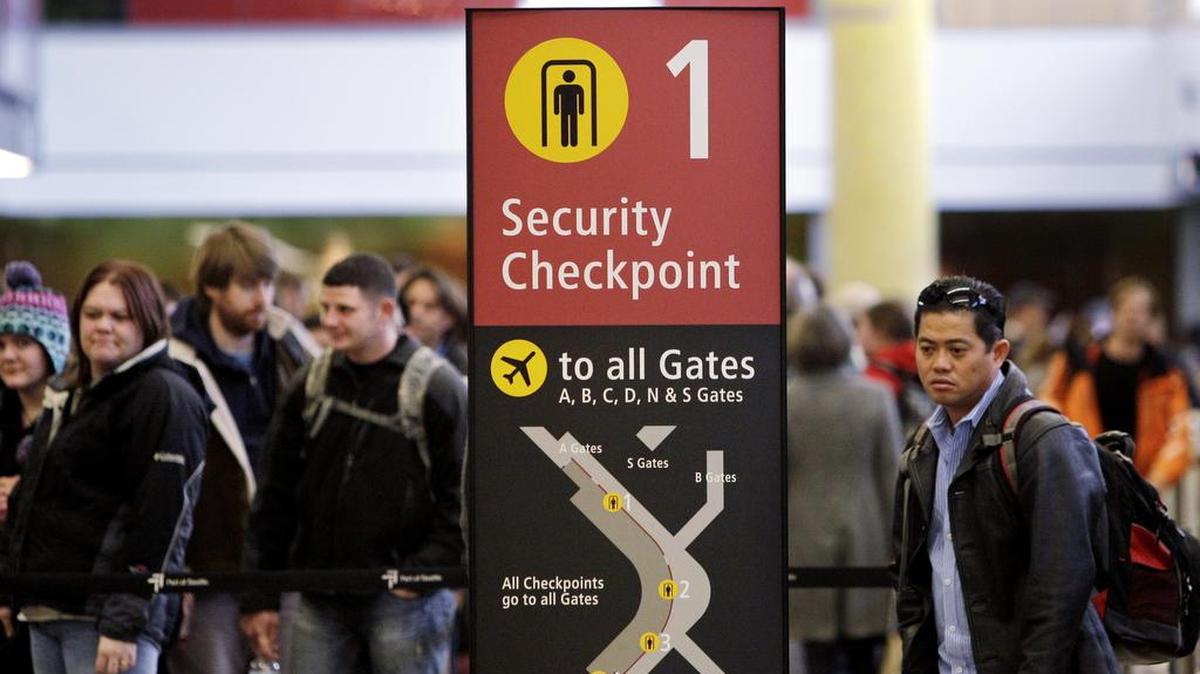 Passengers wait to go through security at Seattle-Tacoma International Airport during the pre-Christmas rush. Getting clearance to fly on a commercial airliner will get more complicated when federal Real ID restrictions go into effect. It’s currently scheduled for January 2018.
