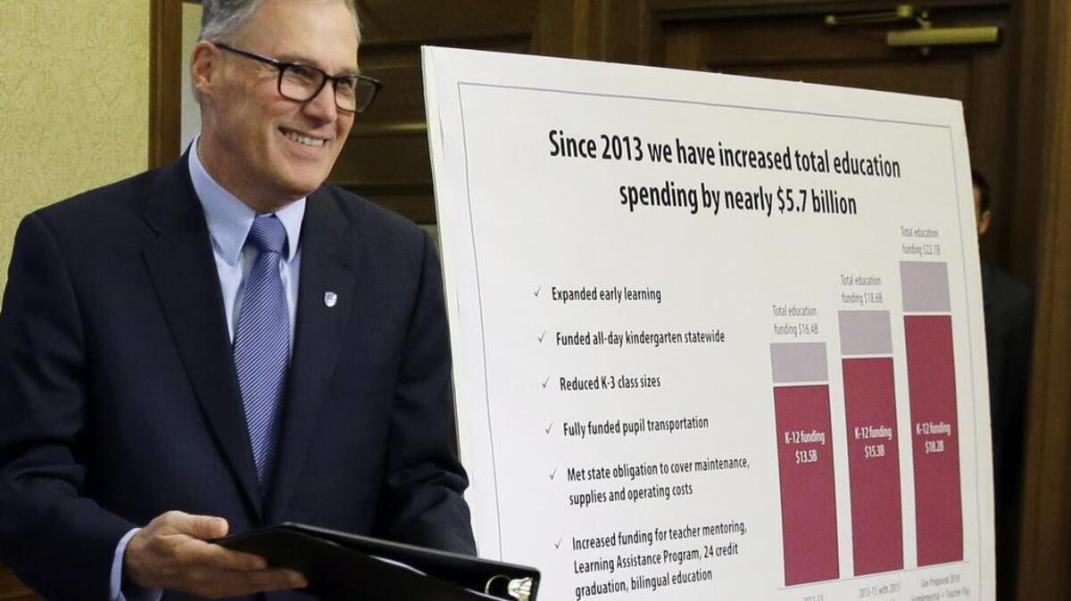 Gov. Jay Inslee arrives to talk to reporters about his proposed supplemental budget plan Dec. 17 in Olympia. He also announced a proposal to increase teacher pay.