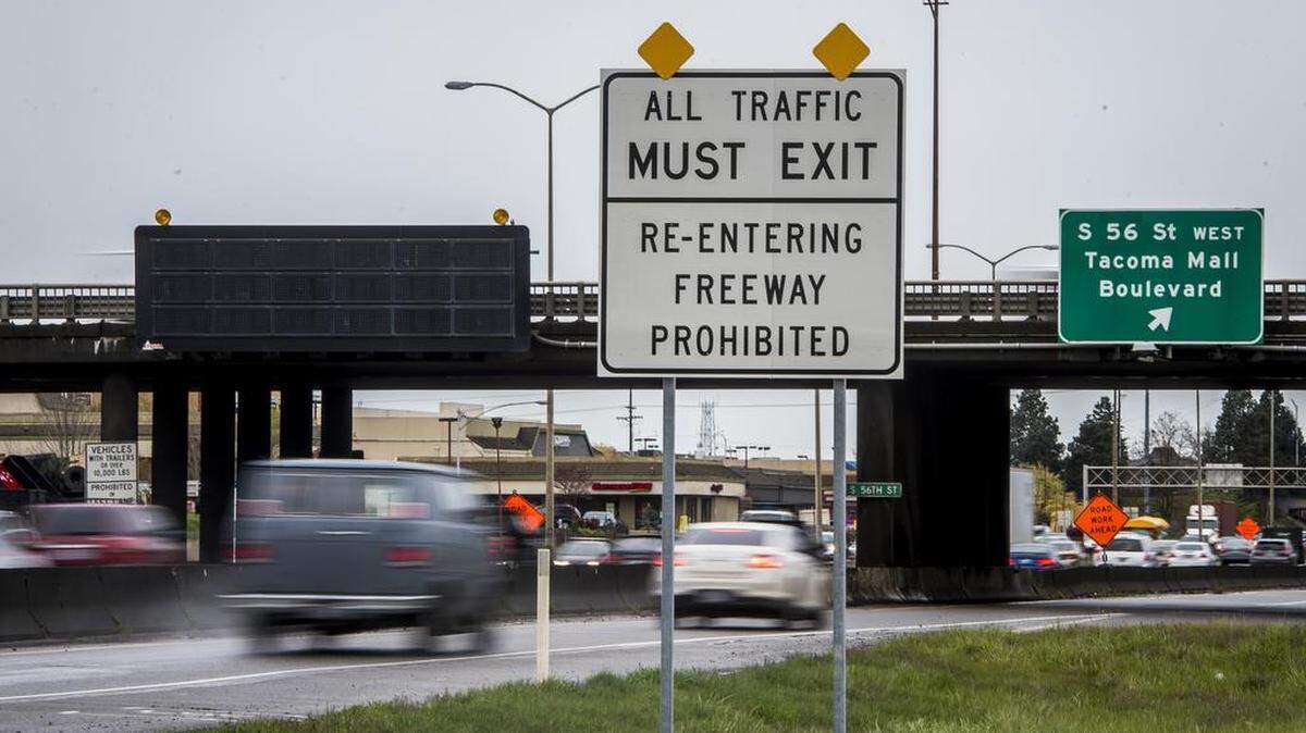 A sign on northbound Interstate 5 at the exit for South 56th Street in Tacoma says you can't re-enter the freeway if you exit. The penalty: a $136 ticket.