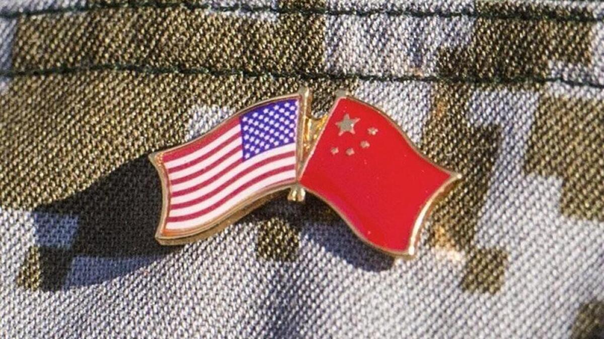 A Chinese soldier wears a pin symbolizing the two countries working together during a disaster management exchange between the U.S military and the People's Liberation Army of China at Joint Base Lewis McChord, November 20, 2015. It was the first one between the two nations conducted on the U.S. mainland.