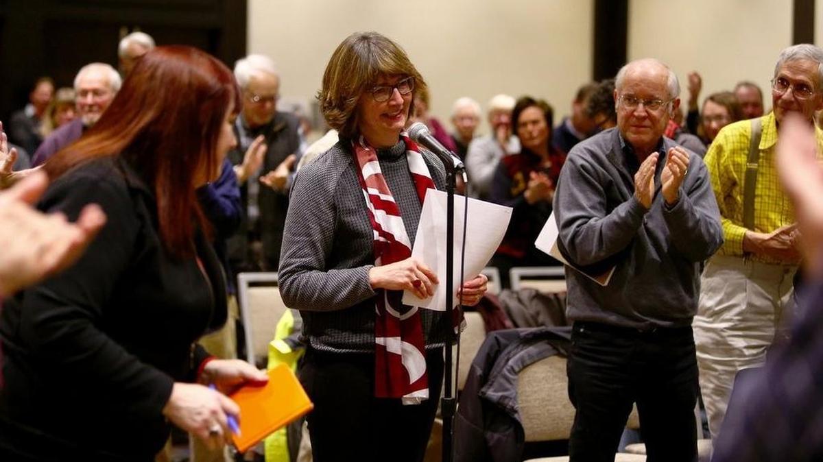 A packed crowd gives a standing ovation to KPLU news director Erin Hennessey at the radio station's Community Advisory Council meeting on Monday in Seattle.