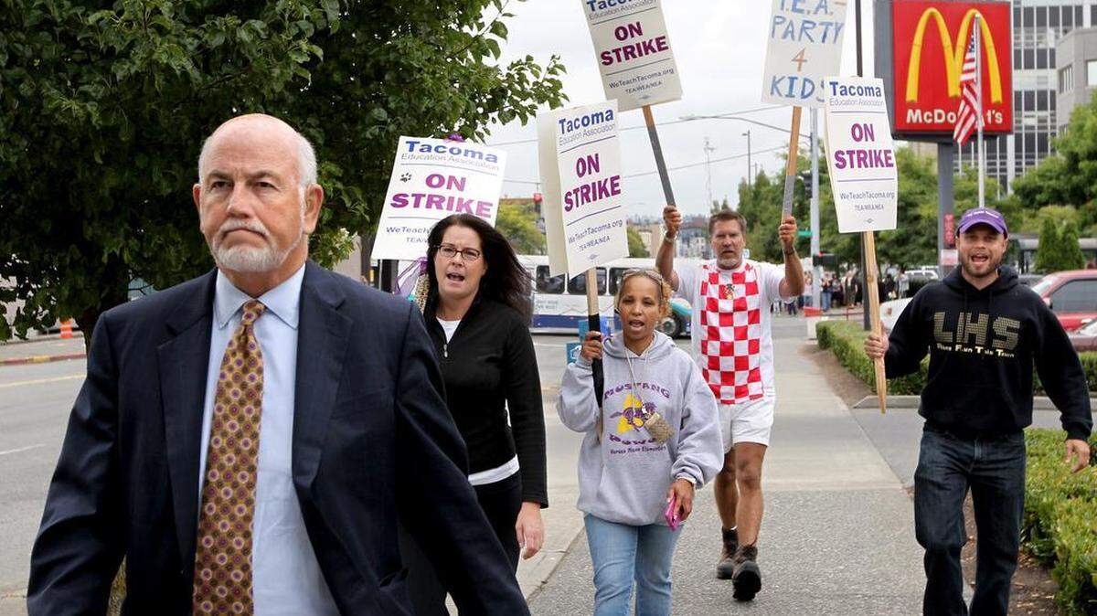 Tacoma School District Superintendent Art Jarvis, who has since retired, is pursued by striking teachers in 2011 after attending a court hearing at which a Pierce County judge said he would issue a temporary restraining order requiring teachers to return to work. Bad blood is one of the enduring effects of teacher strikes, and just one reason why they should be avoided this year.