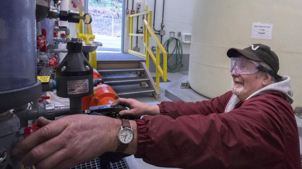 Tacoma Water quality mechanic Craig Carrara monitors the sodium hydroxide being added to the water from ground wells from two 6,600 gallon tanks at the Hood Street Reservoir Groundwater Treatment Facility in early February. The sodium hydroxide helps to raise the pH in the water to keep corrosion down in the pipes.