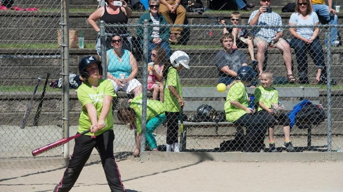 Marissa Gilliam bats for the Skittles team at Sunset Terrace Park in University Place. Youth sports programs are among those that will be cut unless University Place voters approve creation of a metropolitan park district in the April 26 special election.