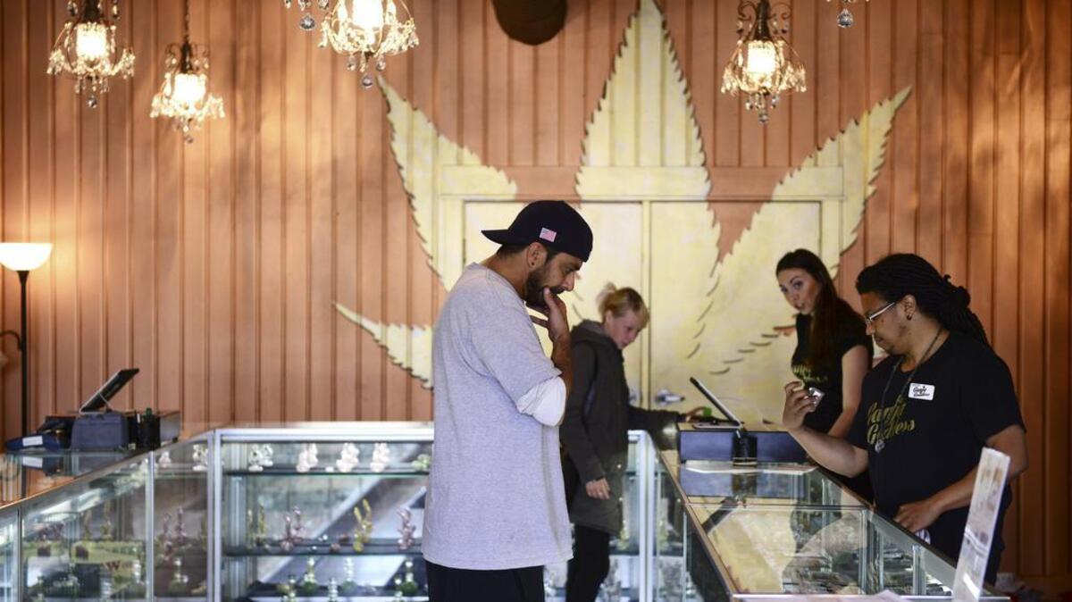 Customers shop at Ganja Goddess, a legal marijuana store in Seattle, in May. Pierce County currently bans licensed pot shops in unincorporated areas.