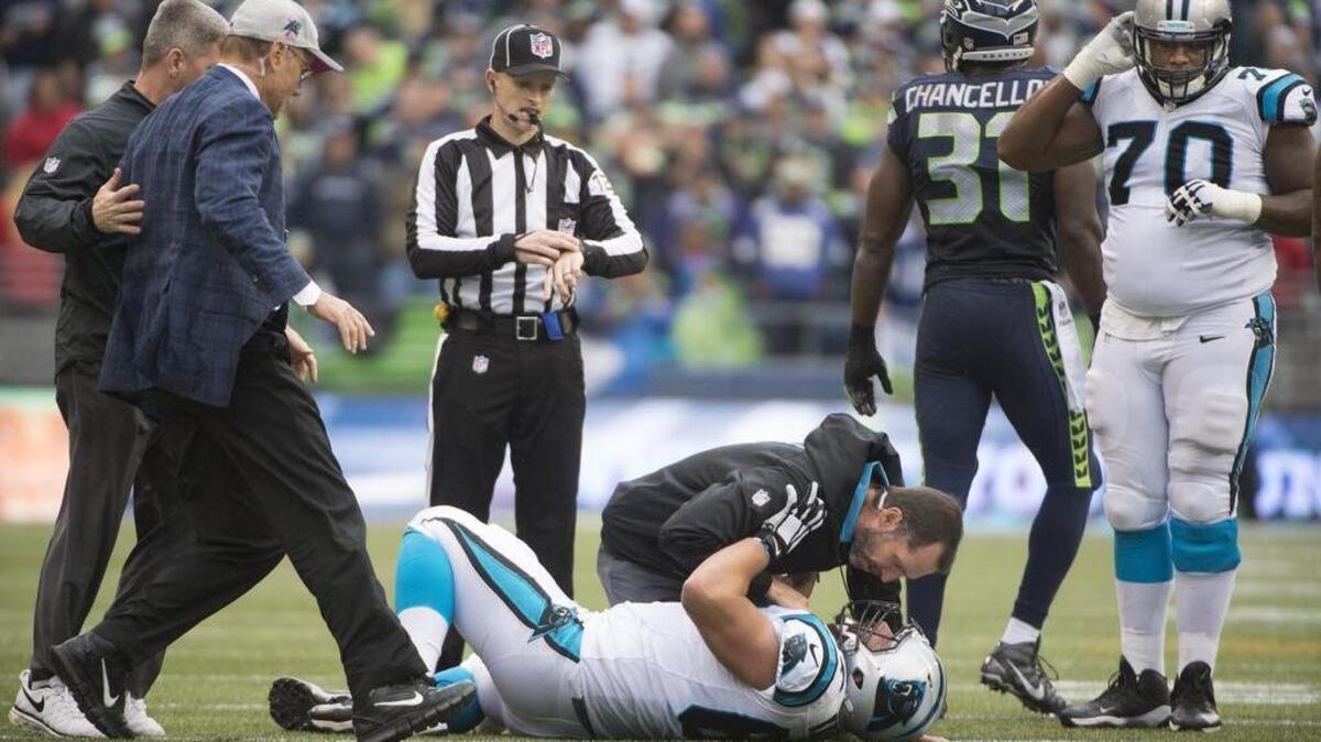 Panthers offensive lineman Ryan Kalil is attended to after suffering a head injury from a collision with Seahawks safety Kam Chancellor during a game at CenturyLink Field on Oct. 18, 2015.