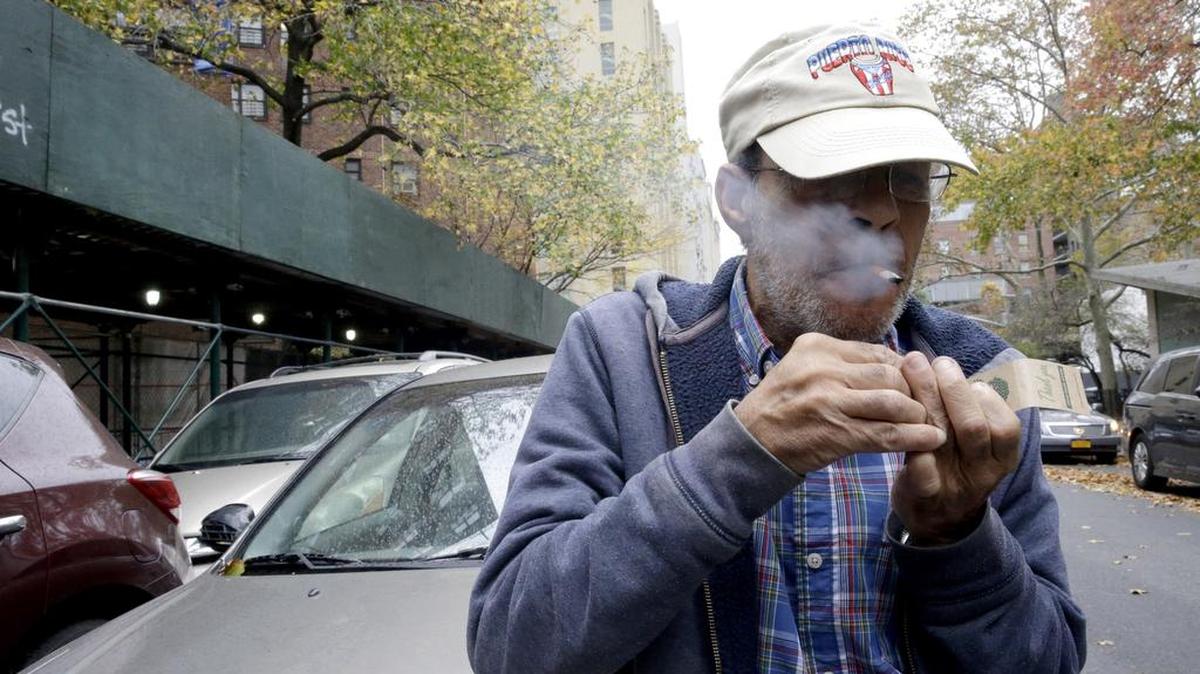 Luis Torres smokes a cigarette Nov. 12 outside the New York City Housing Authority's Chelsea-Elliot Houses where he lives. The Department of Housing and Urban Development proposed a rule Nov. 12 to require the more than 3,100 public housing agencies across the country to make their properties smoke-free. Tacoma Housing Authority has had such a ban since 2014.