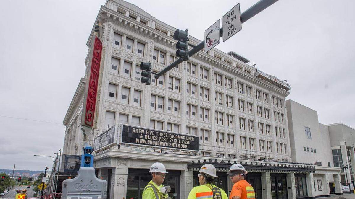 Workers plan their next steps outside Tacoma's Pantages Theater, which had some exterior renovations done two summers ago in an early phase of the current centennial project.