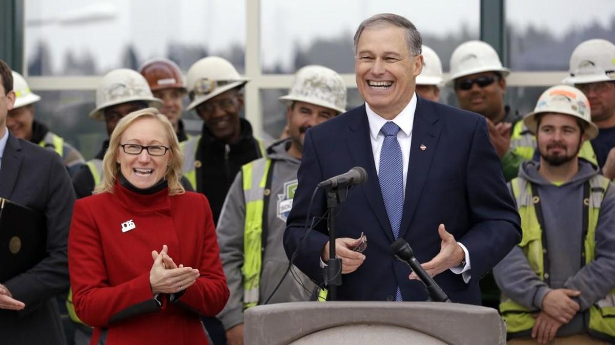 Washington Gov. Jay Inslee is shown with former Transportation Secretary Lynn Peterson during better days, in 2014, at construction site of a floating bridge on Lake Washington. The state Senate rejected the gubernatorial appointment of Peterson last week.