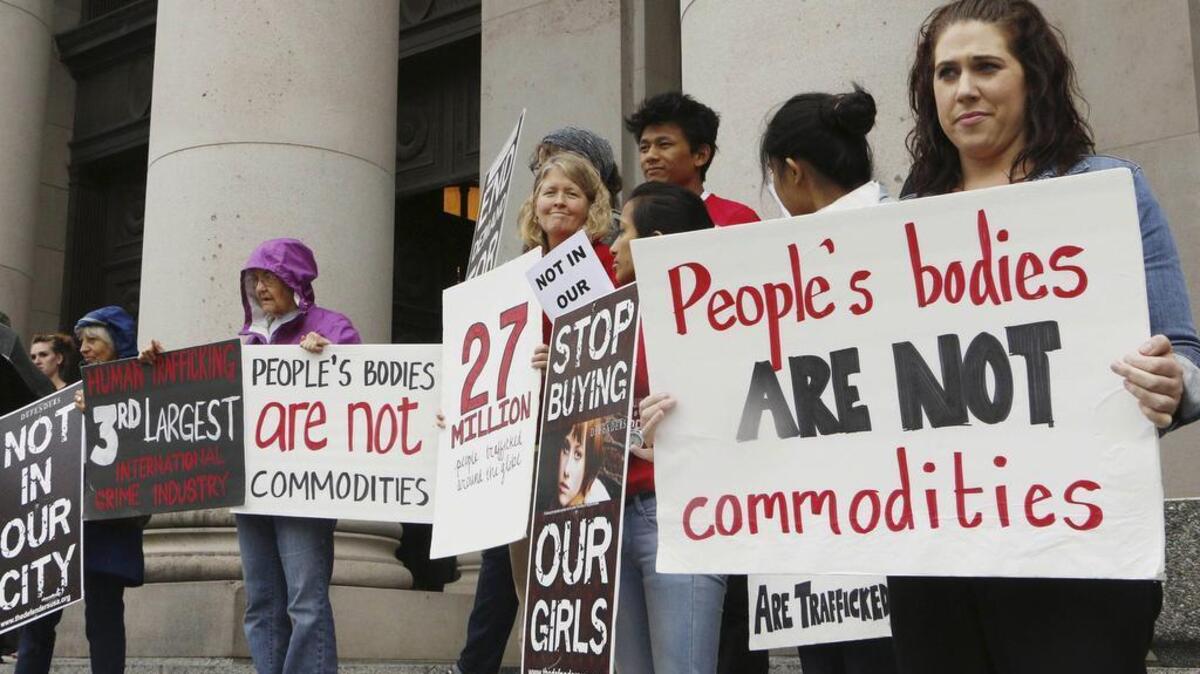 
People opposed to child sex trafficking rally outside of the Washington Supreme Court in Olympia in 2014. The court ruled Thursday in favor of three young girls who sued Backpage.com, claiming they were sold as prostitutes on the site. 
