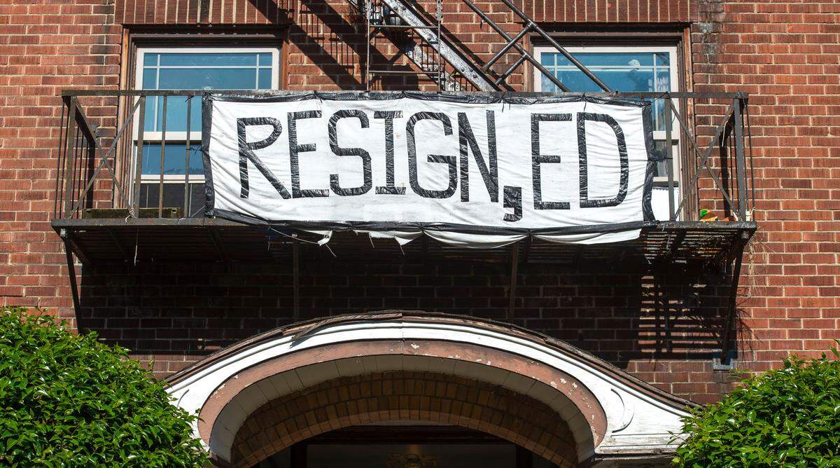 A sign calling for Pierce County Sheriff Ed Troyer’s resignation hangs from an apartment balcony adjacent to Tacoma’s Wright Park Monday, July 26, 2021.