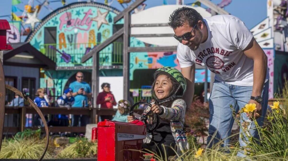 Avril Pena and her dad Fernando have fun together at the 2015 Washington State Fair, the year before the fair made a big switch to a longer schedule with an earlier launch over Labor Day weekend.