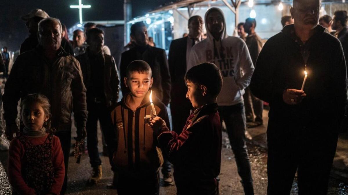 Iraqi Christians hold candles at a camp for the displaced in Irbil, northern Iraq.