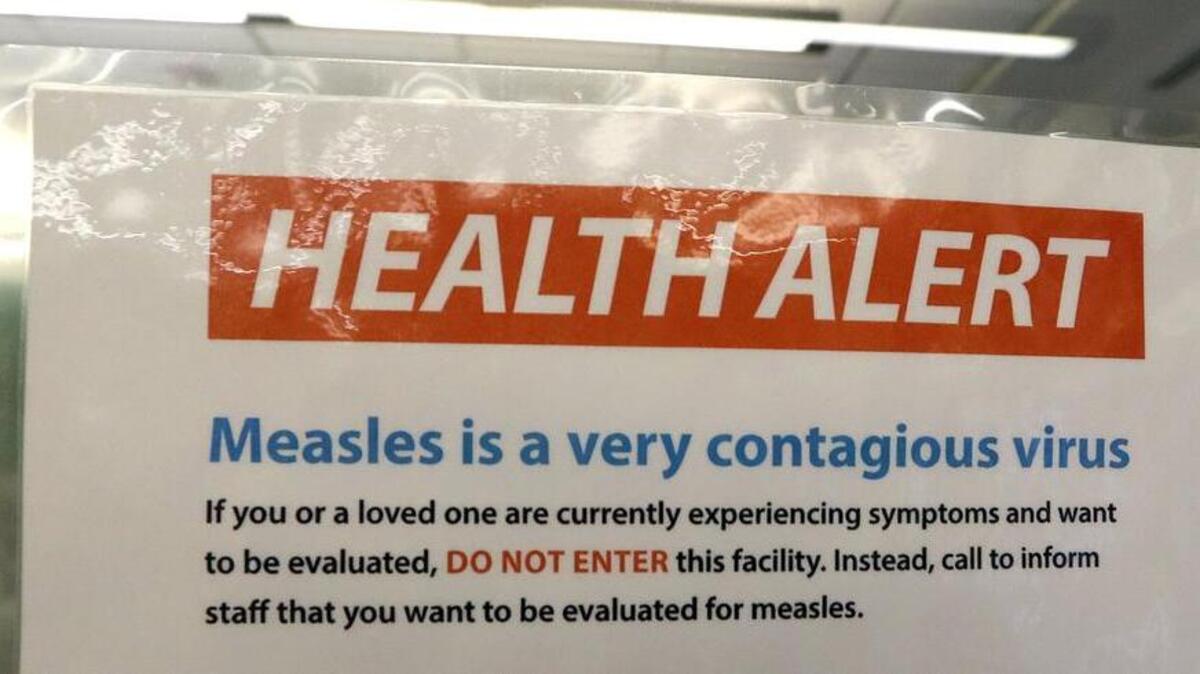 A notice for a health alert about measles is posted on the door of a medical facility in Seattle on Feb. 13. Washington Gov. Jay Inslee declared a state of emergency over a Clark County outbreak last month.