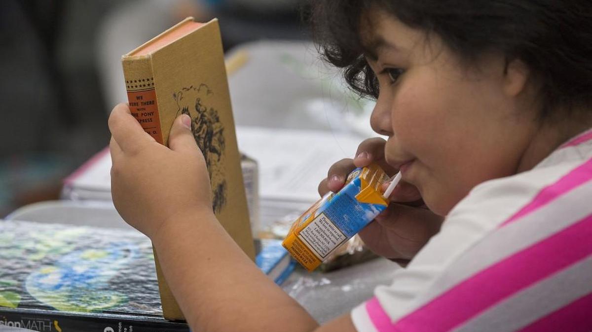 A child works at a classroom desk while eating breakfast at White Rock Elementary School in Rancho Cordova, California. It is one of many American schools where students eat a free breakfast in their classrooms. Will the trend come to Washington?
