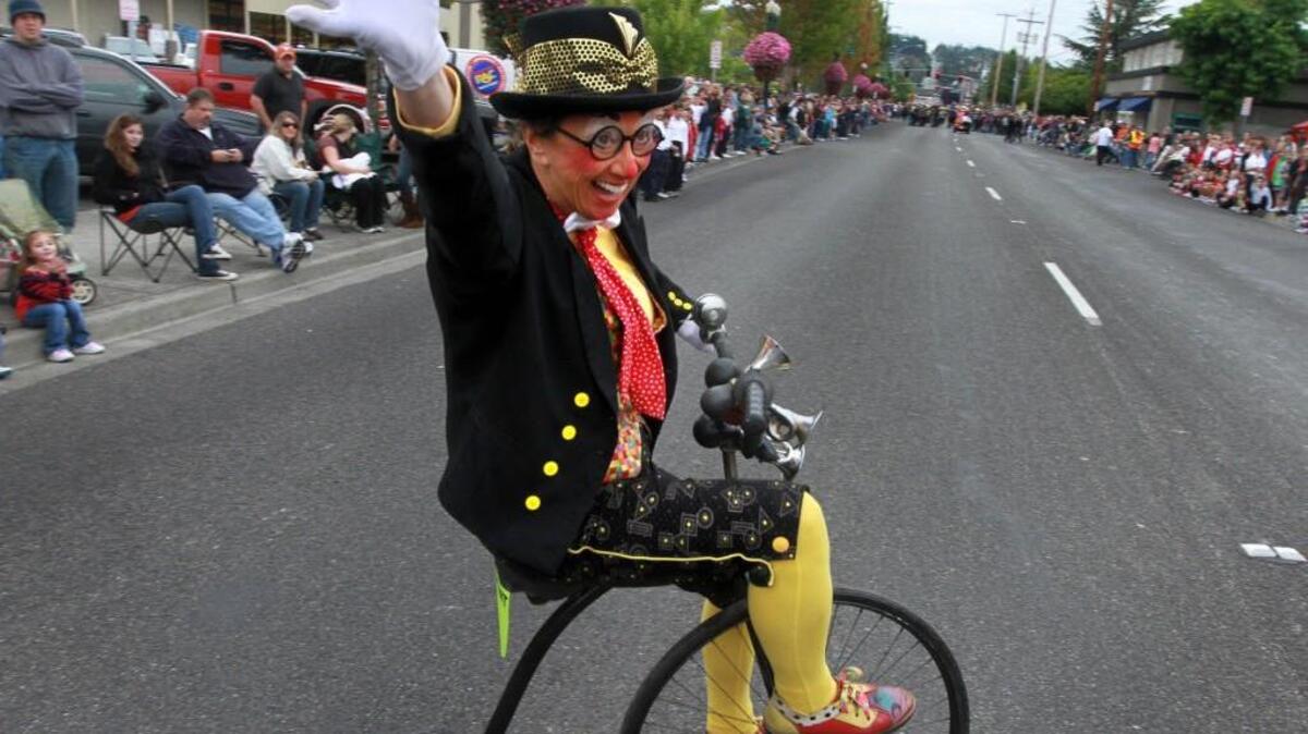 A clown gives the five-spot salute (otherwise known as a wave to the crowd) during the 2010 Western Rodeo Parade, one of the kickoff events for opening day of the Washington State Fair in Puyallup. This year, for the first time, the fair opened early, during Labor Day weekend.