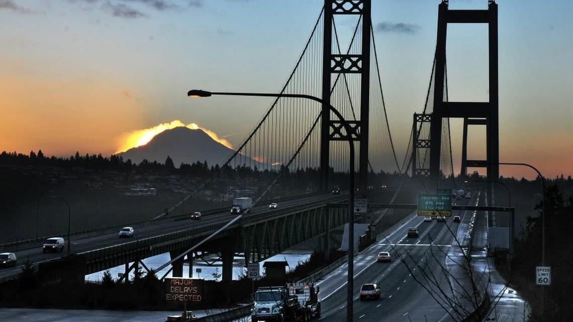 Sunrise greets Tacoma Narrows Bridge commuters driving on the newer eastbound span toward Tacoma (right) as well as those on the old bridge heading toward the Peninsula.